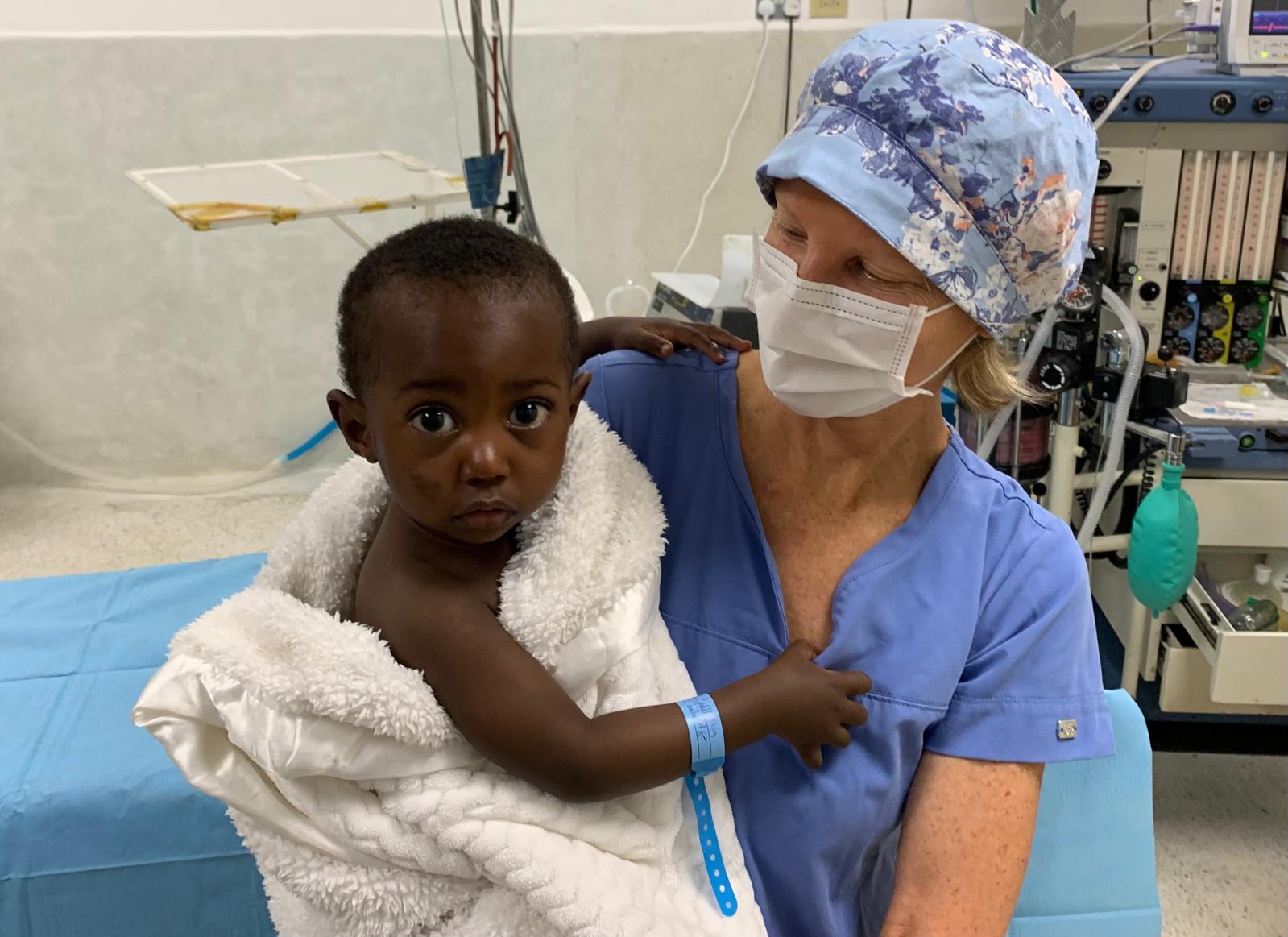 ENT surgeon with child patient at AGC Tenwek Hospital